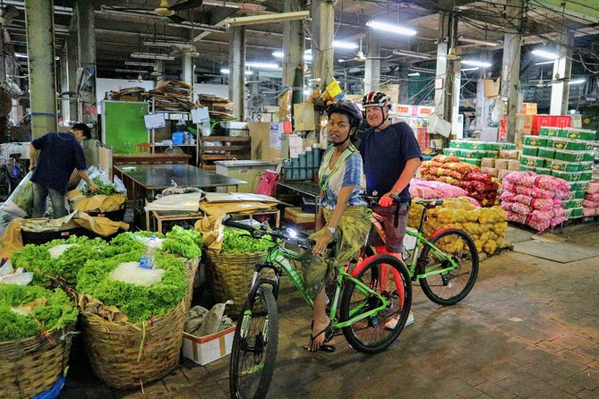 Bike Bangkok at Night with Thai Dinner - Wat Arun glowing beside the river