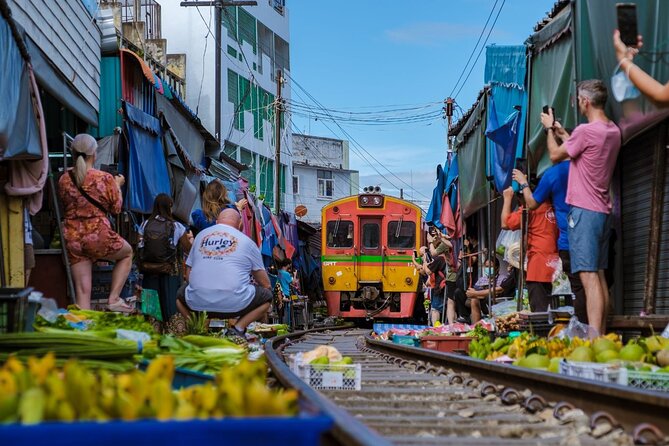 Damnoen Saduak Floating Market & Ayutthaya Tour from Bangkok - Maeklong Railway Market and the train through the stalls