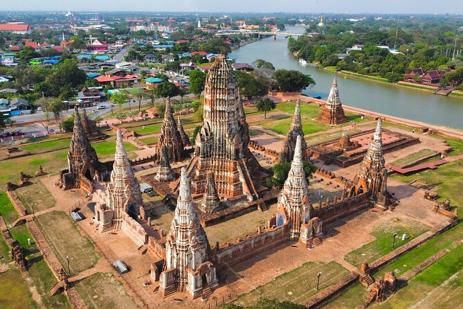 Discover Ayutthaya at Sunset: Historic Temples & River Cruise - Wat Mahathat and the famous Buddha in the roots