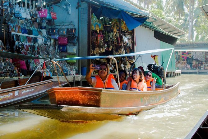 Private Tour from Bangkok: Railway and Floating Markets Tour - A boat through village canals leads to Damnoen Saduak