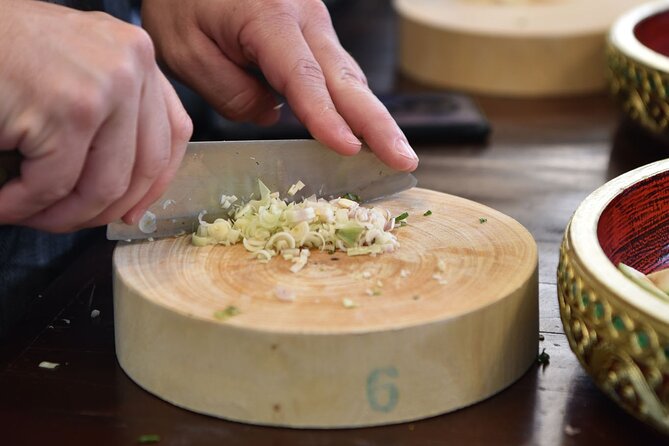 Thai Cooking Class with Market Tour in Sathon Bangkok - Grinding curry paste by hand